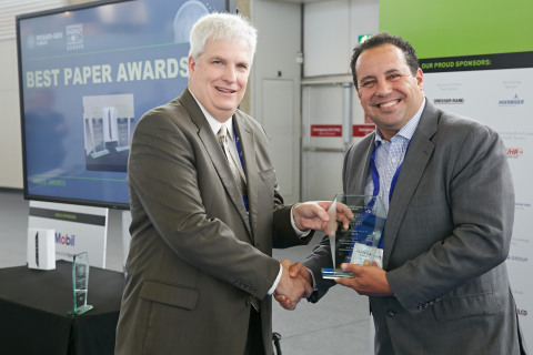 Richard G. Baker, Senior Vice President, Power Division of PennWell, presents "Best Paper" award to ...